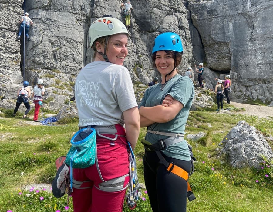 Participants of WRF2022, women climbing and holding the WRF flag