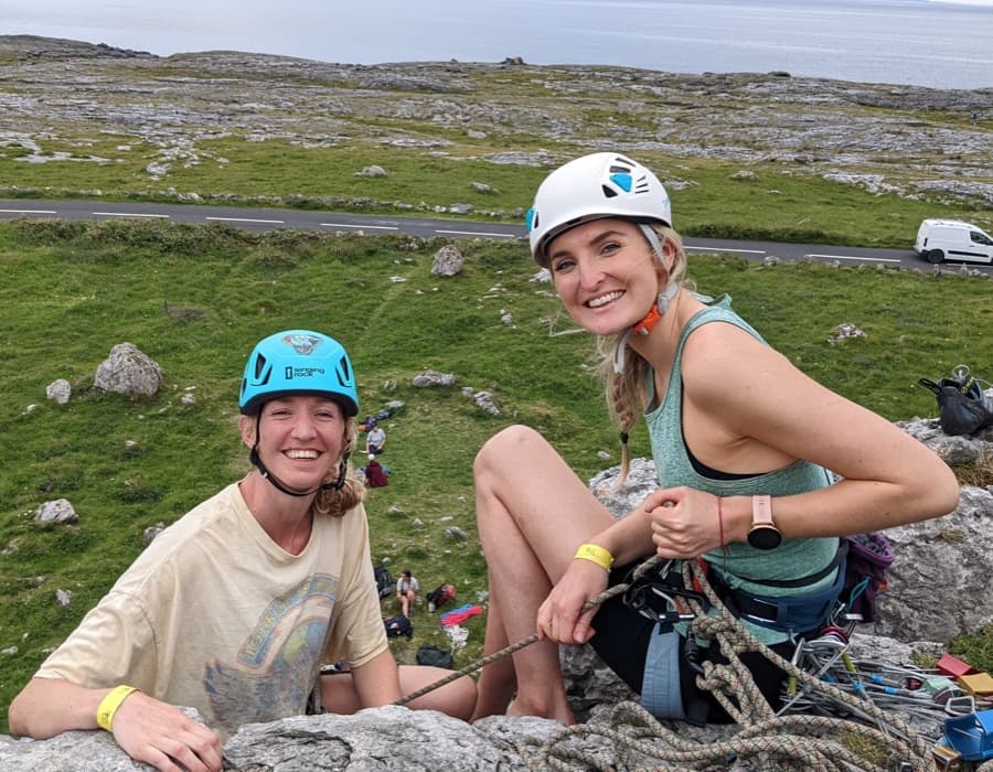 Participants of WRF2022, women climbing and holding the WRF flag